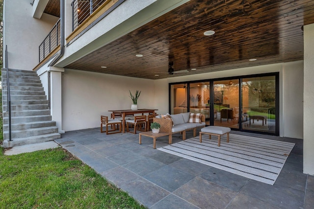 view of patio / terrace with outdoor dining space, stairway, and outdoor lounge area