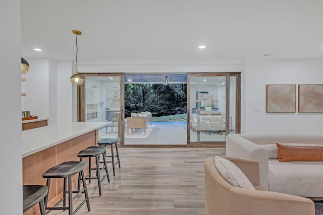 living room with light wood-style flooring and recessed lighting