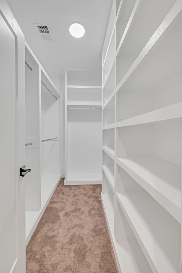 walk in closet featuring carpet floors and visible vents