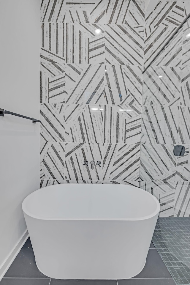 bathroom featuring a soaking tub and tile patterned floors