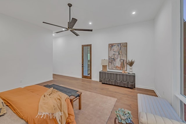 living room featuring ceiling fan, baseboards, wood finished floors, and recessed lighting