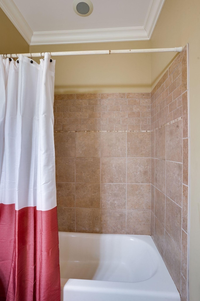 bathroom with crown molding and shower / bath combo with shower curtain