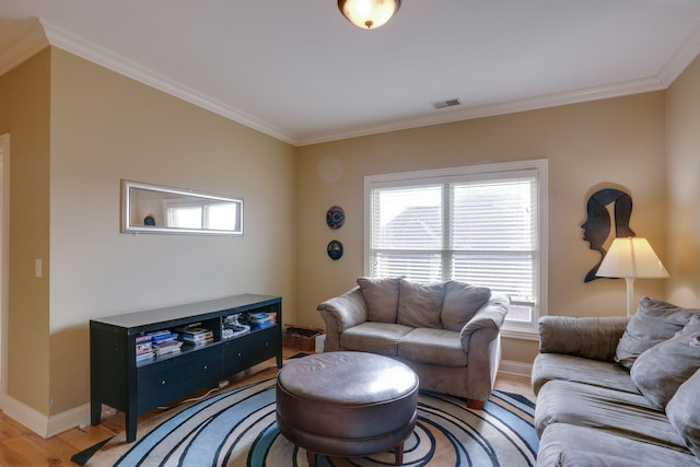 living room with hardwood / wood-style floors, ornamental molding, and a wealth of natural light