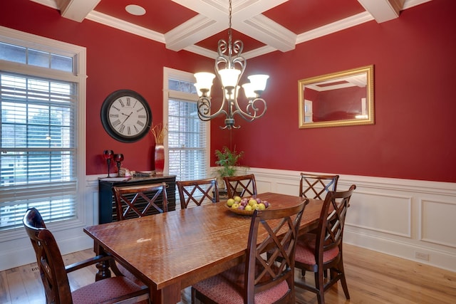 dining area featuring an inviting chandelier, light wood-type flooring, plenty of natural light, and crown molding