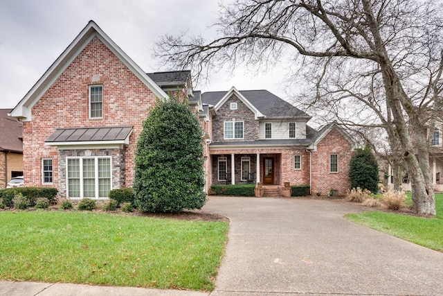 view of front property featuring covered porch and a front yard