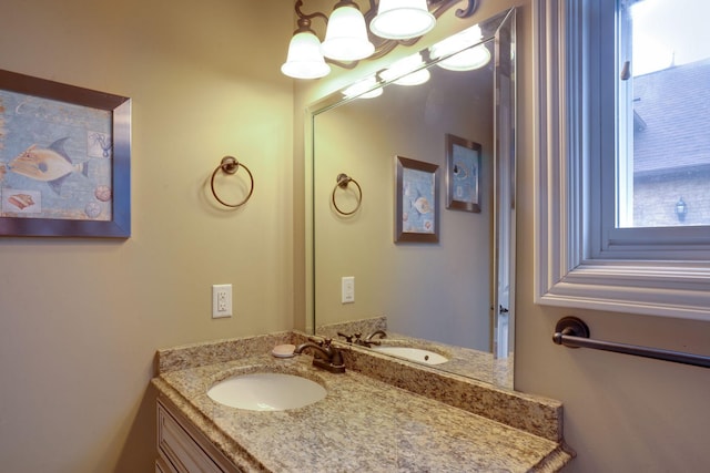 bathroom featuring vanity, plenty of natural light, and a chandelier