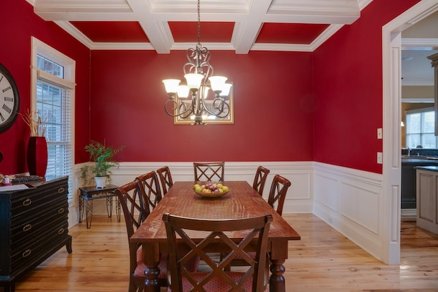 dining room featuring light hardwood / wood-style flooring, crown molding, and a chandelier