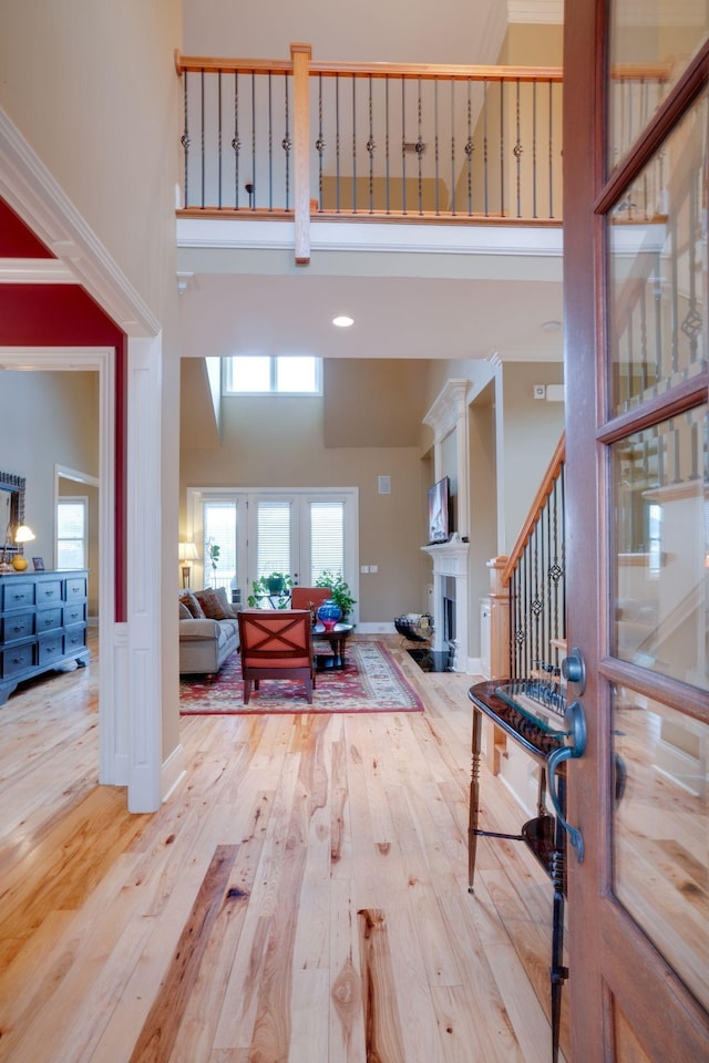 entrance foyer with light hardwood / wood-style flooring and a high ceiling