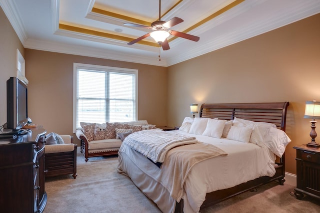 carpeted bedroom featuring ceiling fan, crown molding, and a raised ceiling