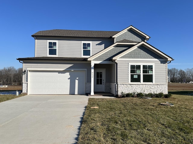 craftsman inspired home featuring a garage and a front yard