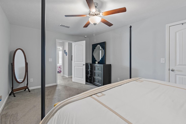 bedroom featuring ceiling fan, dark carpet, and a textured ceiling