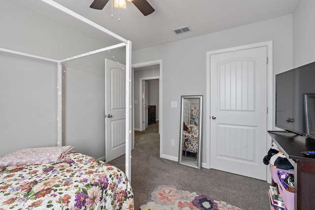 bedroom with ceiling fan and dark colored carpet