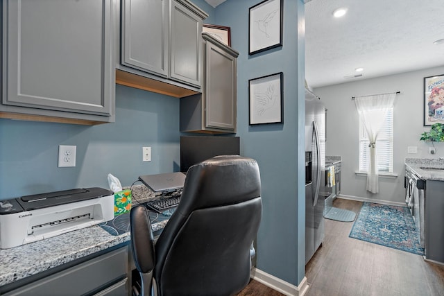 office area featuring sink, a textured ceiling, and dark hardwood / wood-style floors