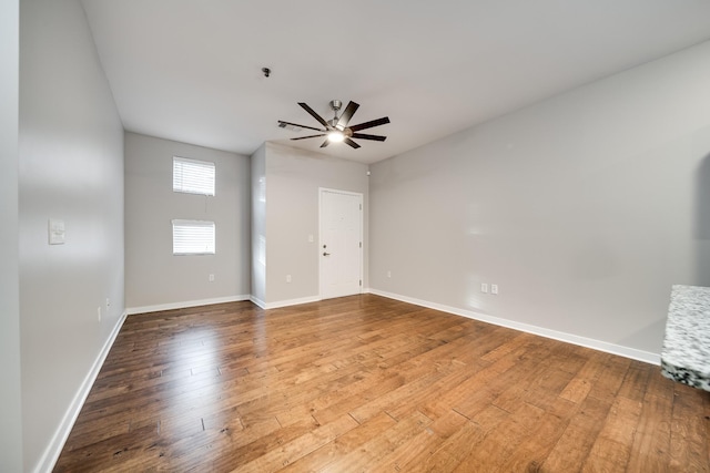 spare room featuring ceiling fan and hardwood / wood-style floors