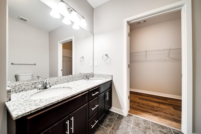 bathroom featuring toilet and vanity