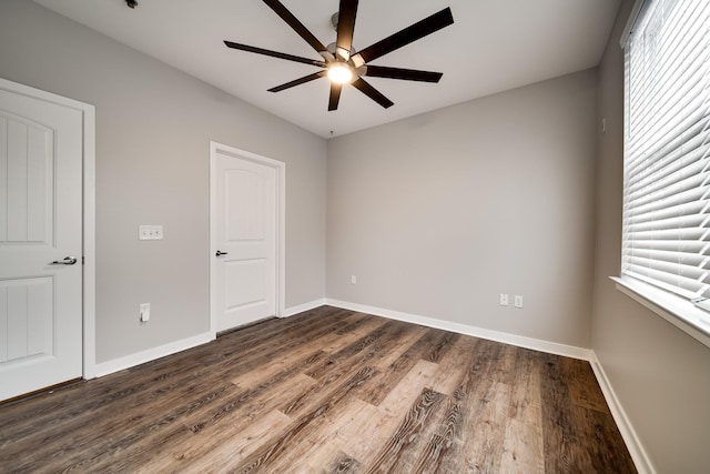 empty room featuring ceiling fan and dark hardwood / wood-style flooring