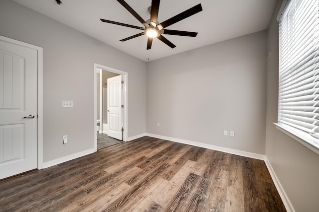 unfurnished bedroom featuring ceiling fan and dark wood-type flooring