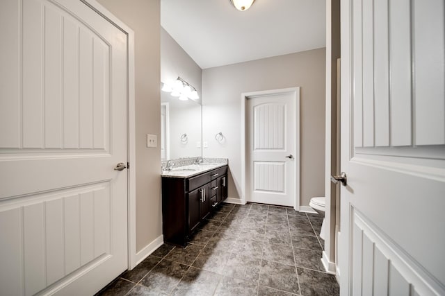 bathroom featuring toilet and vanity