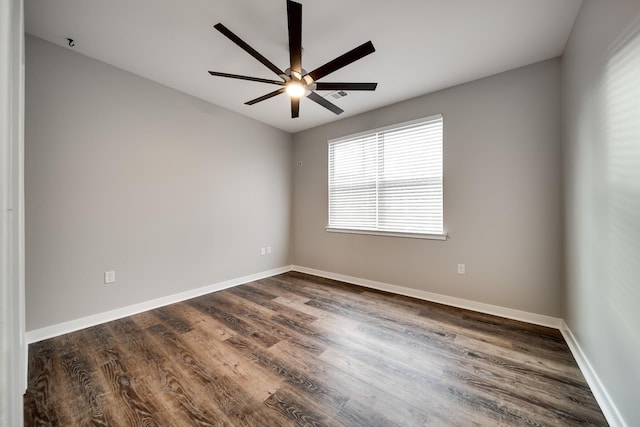 spare room featuring ceiling fan and dark hardwood / wood-style flooring