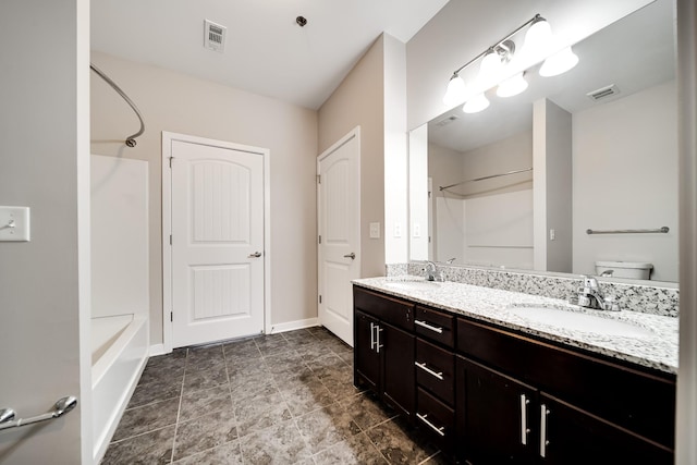 full bathroom with toilet, vanity, and washtub / shower combination