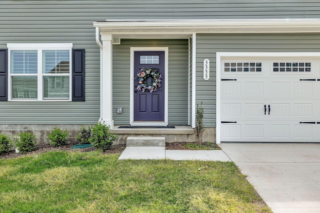 doorway to property featuring a garage and a lawn