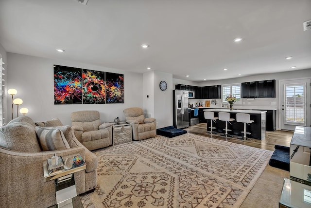 living room featuring plenty of natural light and light hardwood / wood-style floors