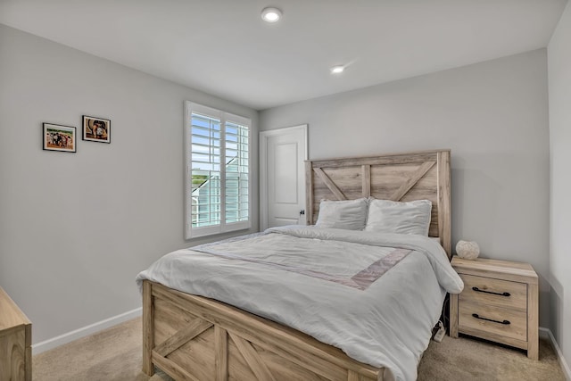 bedroom featuring light colored carpet