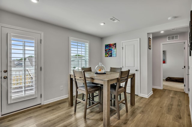 dining space with light hardwood / wood-style flooring