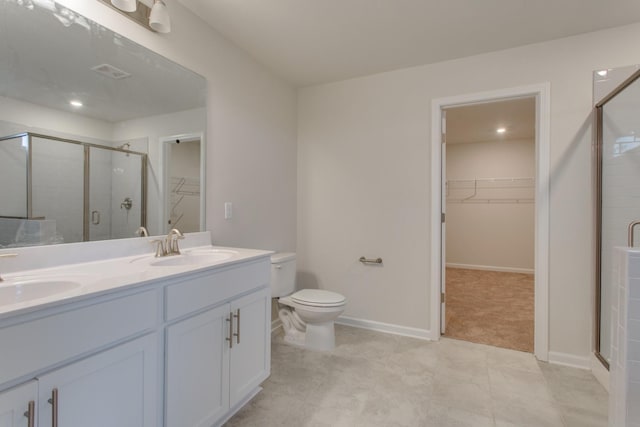 bathroom featuring an enclosed shower, vanity, and toilet