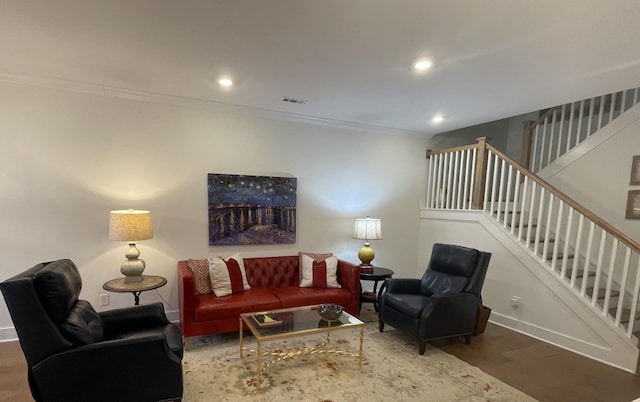 living room with ornamental molding and hardwood / wood-style floors