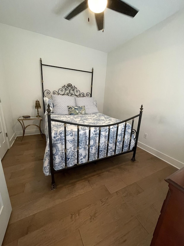 bedroom with ceiling fan and dark wood-type flooring