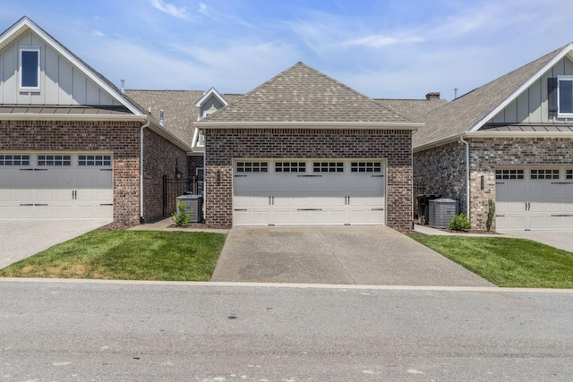 view of front facade featuring a garage and central AC