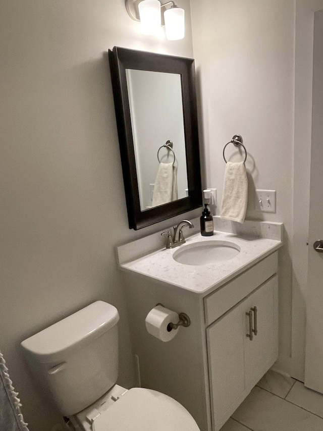 bathroom featuring toilet, vanity, and tile patterned floors