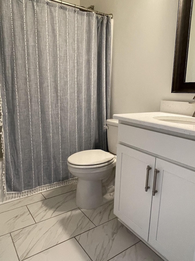 bathroom with toilet and vanity