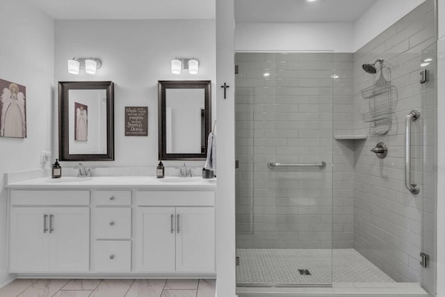 bathroom with a shower with door and vanity