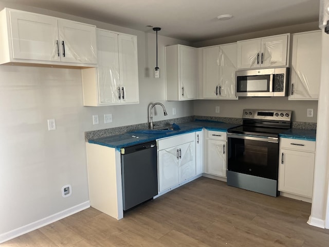 kitchen with white cabinetry and appliances with stainless steel finishes