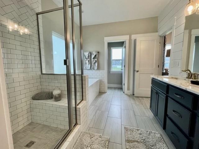 bathroom with separate shower and tub and vanity