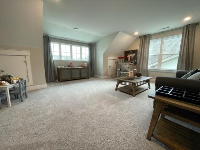 interior space featuring light carpet and lofted ceiling