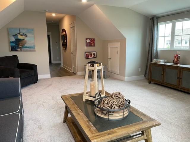 interior space with lofted ceiling and carpet floors