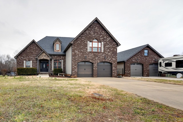 view of front of property with a garage and a front lawn