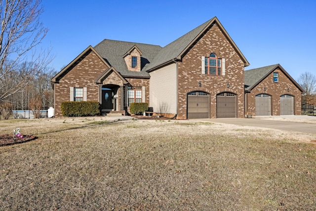 view of front of house with a garage and a front lawn