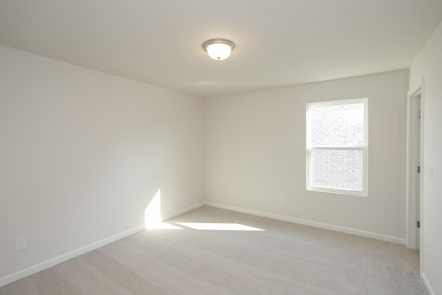 unfurnished room with light carpet