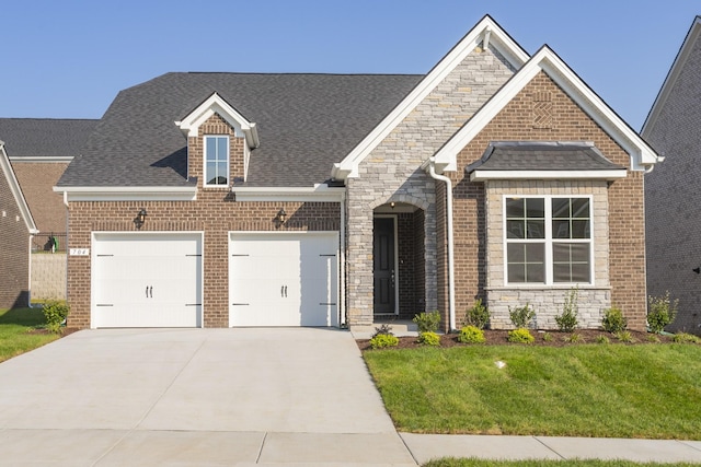 view of front of house featuring a garage and a front yard