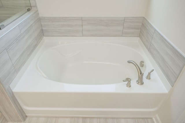 bathroom with a tub to relax in