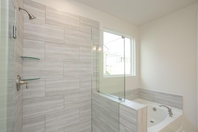 bathroom featuring shower with separate bathtub