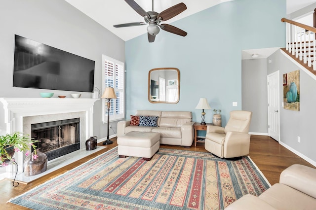 living room with vaulted ceiling, ceiling fan, and hardwood / wood-style flooring