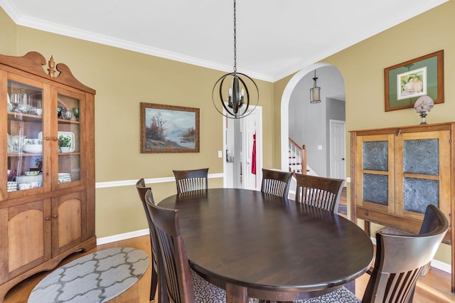 dining space featuring an inviting chandelier and ornamental molding