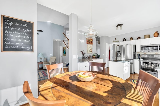 dining space featuring light hardwood / wood-style flooring and a notable chandelier