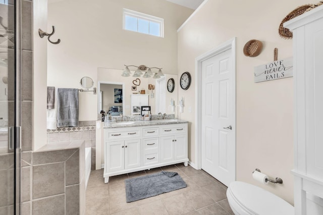 bathroom with toilet, tile patterned flooring, an enclosed shower, and vanity