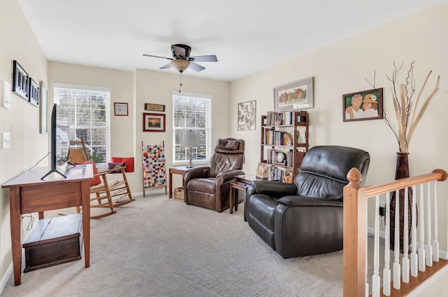 sitting room featuring carpet and ceiling fan